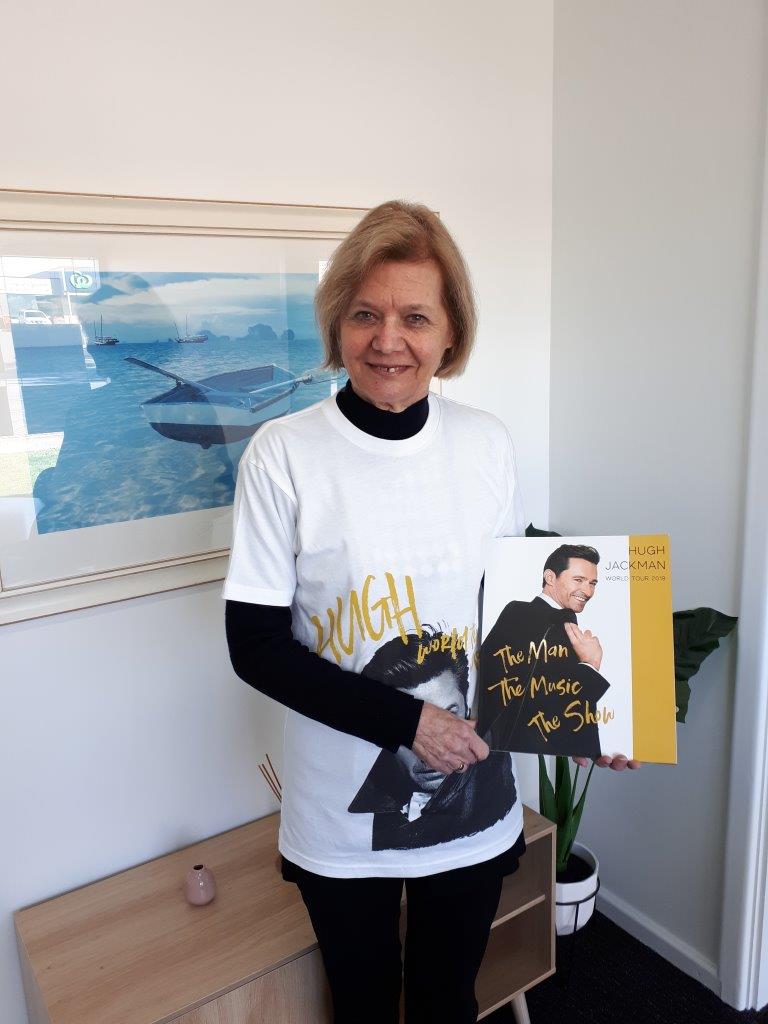 Pam Hennessy with Hugh Jackman book and tshirt - Christies Beach real estate staff